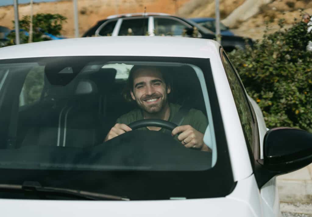 Caleb getting ready to drive off in a rental car in Naxos