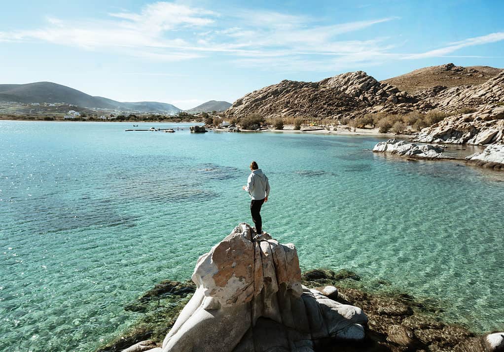 Caleb standing on a rock for an epic view of Kolymbithres Beach
